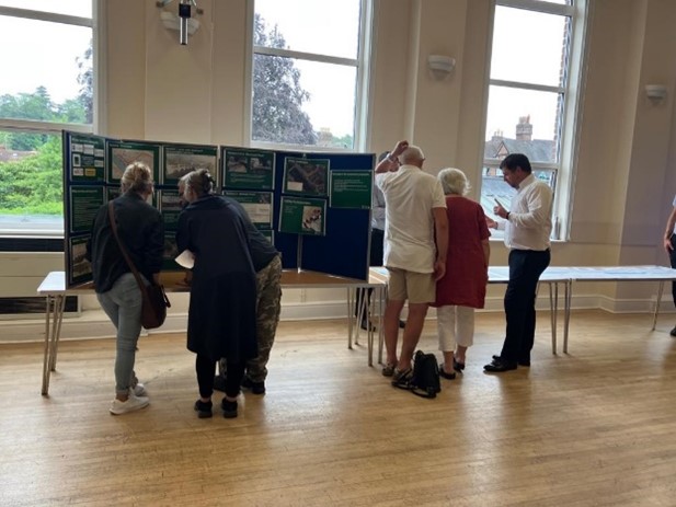 Picture shows members of the public looking at the drop-in displays and speaking with members of the project team