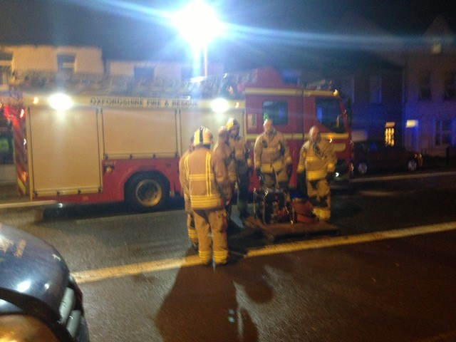 Firemen and fire engine at night responding to flooding