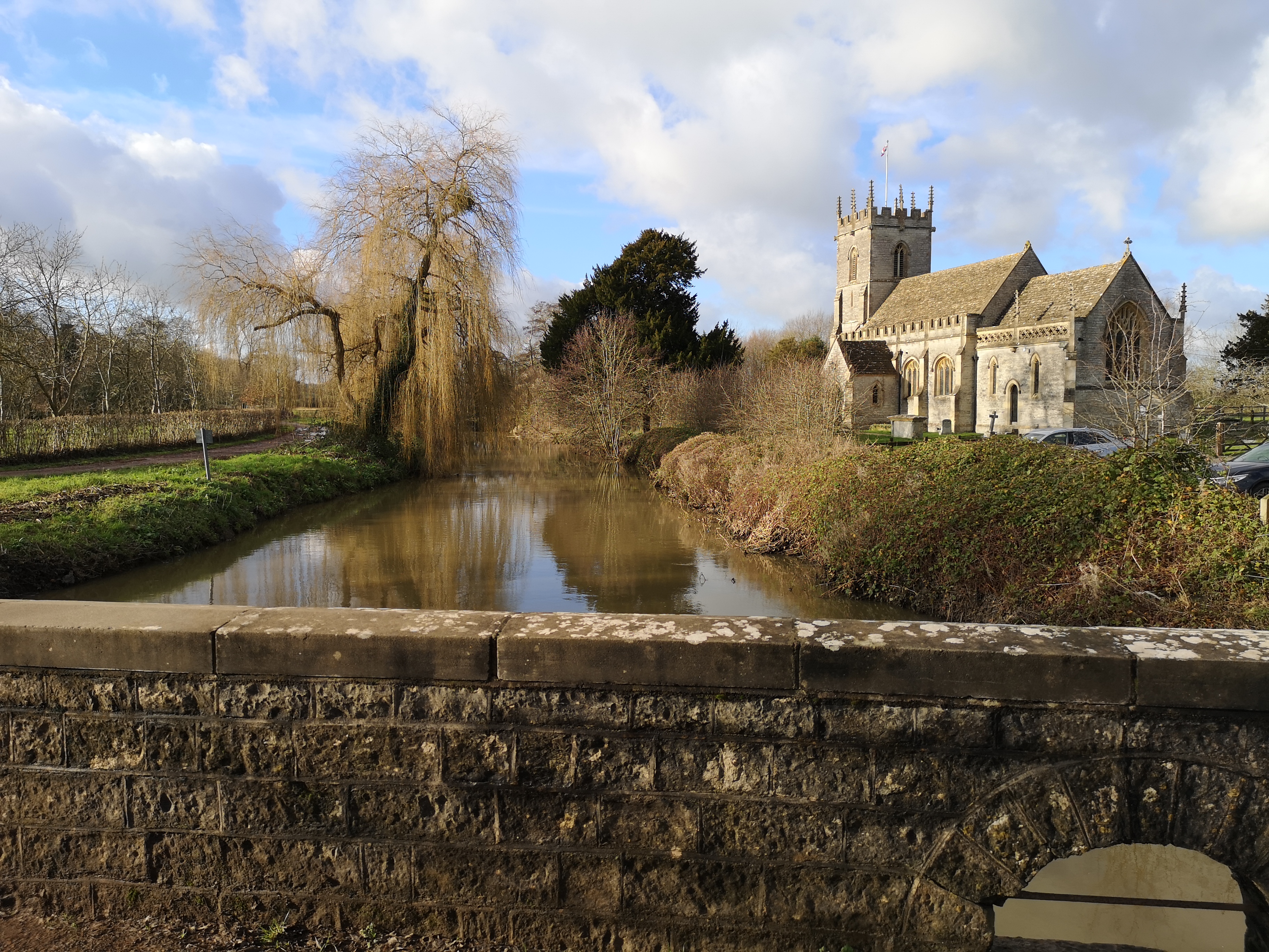 A photo showing West Lydford, overlooking St Peter’s Church and  the River Brue