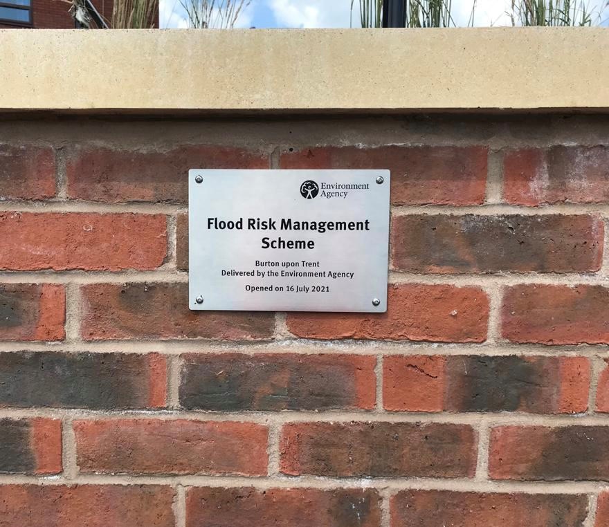 The plaque commemorating the opening event on the new flood wall by the library